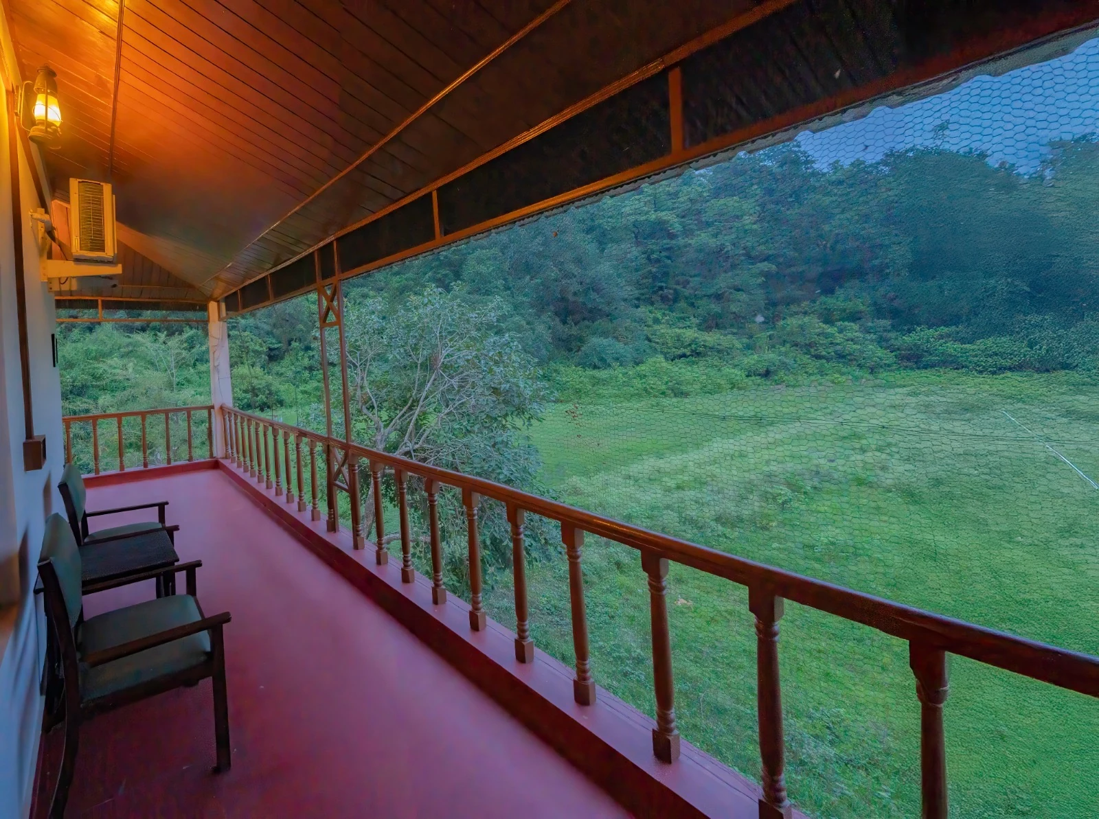 Twilight Forest Verandah - Expansive wooden balcony overlooking lush Corbett meadows